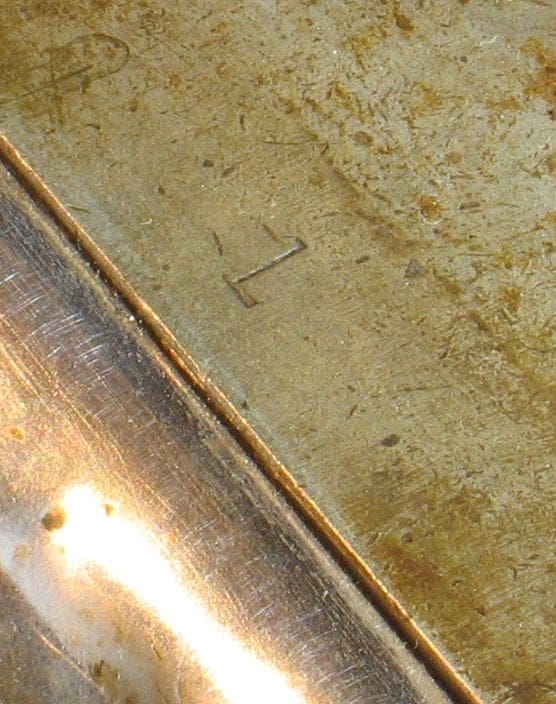 Hand-stamped serial number 1 on the knee of the machine