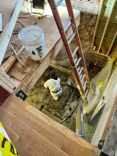 Crews cut away the old concrete in the basement floor to lay the new reinforced foundation for the LULA (Nov 2025)